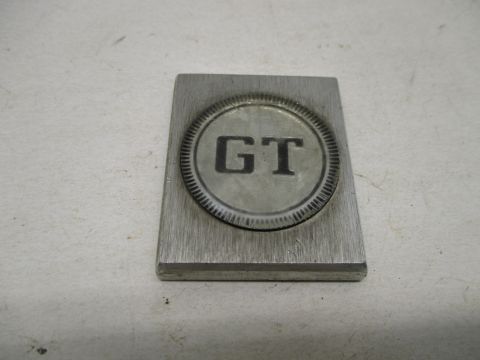 "GT" medallion
